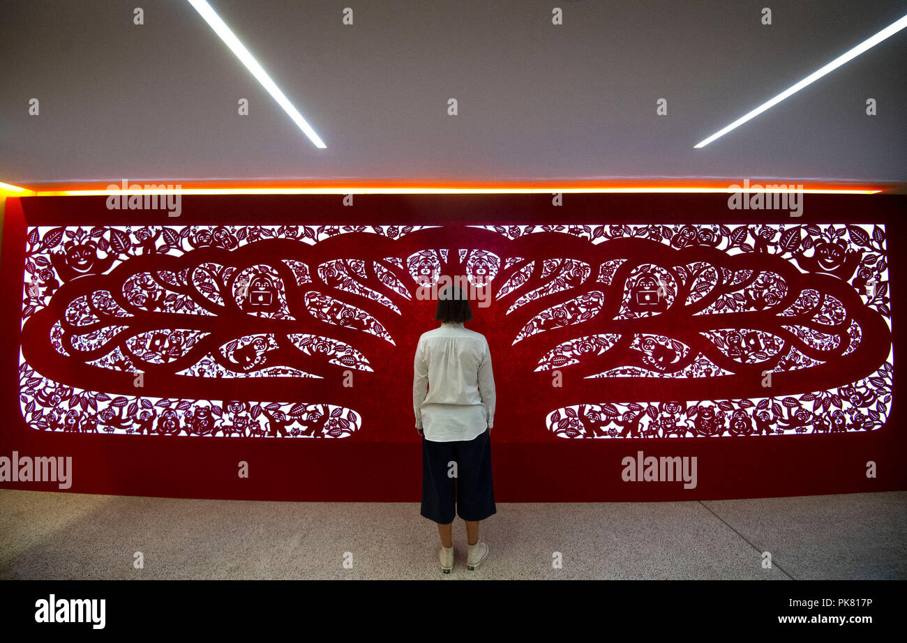 A hand-cut construction hoarding made using a traditional Chinese paper-cutting technique, designed by Yang Shiyi for the Apple store in Taipei, during a media preview of the Beazley Designs of the Year, an annual celebration of the most innovative and impactful products and concepts, at the Design Museum in London. Stock Photo