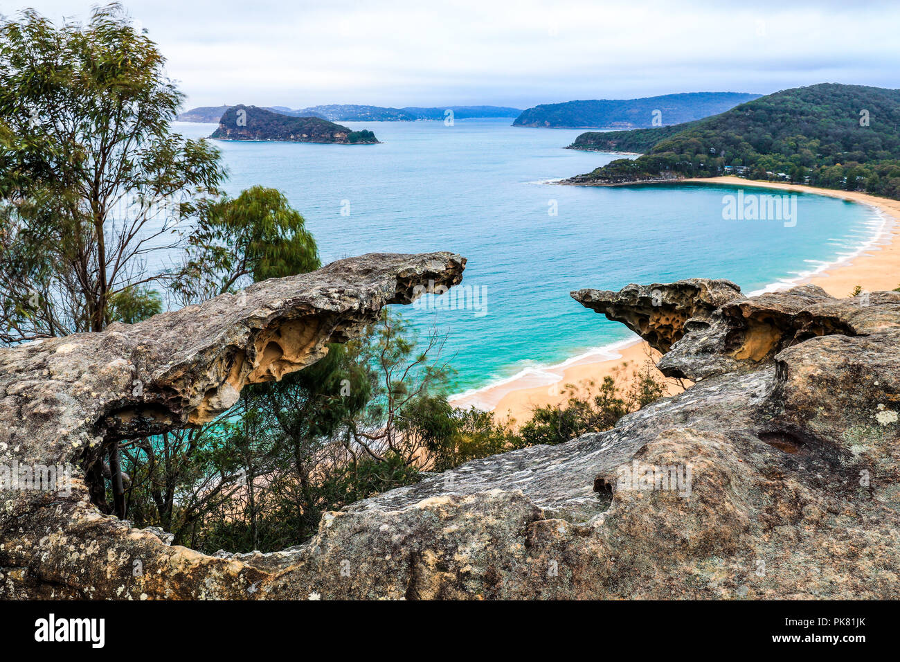 High view over ocean and beach through rocky outcrop Stock Photo