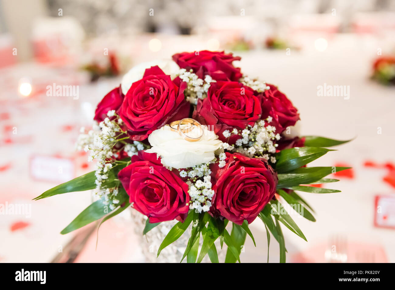 Wedding Rings on White and Red Roses Bridal Bouquet Stock Photo