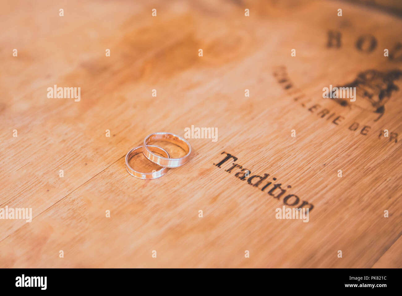 Wedding Rings and Tradition Engraved on Wooden Wine Barrel Stock Photo