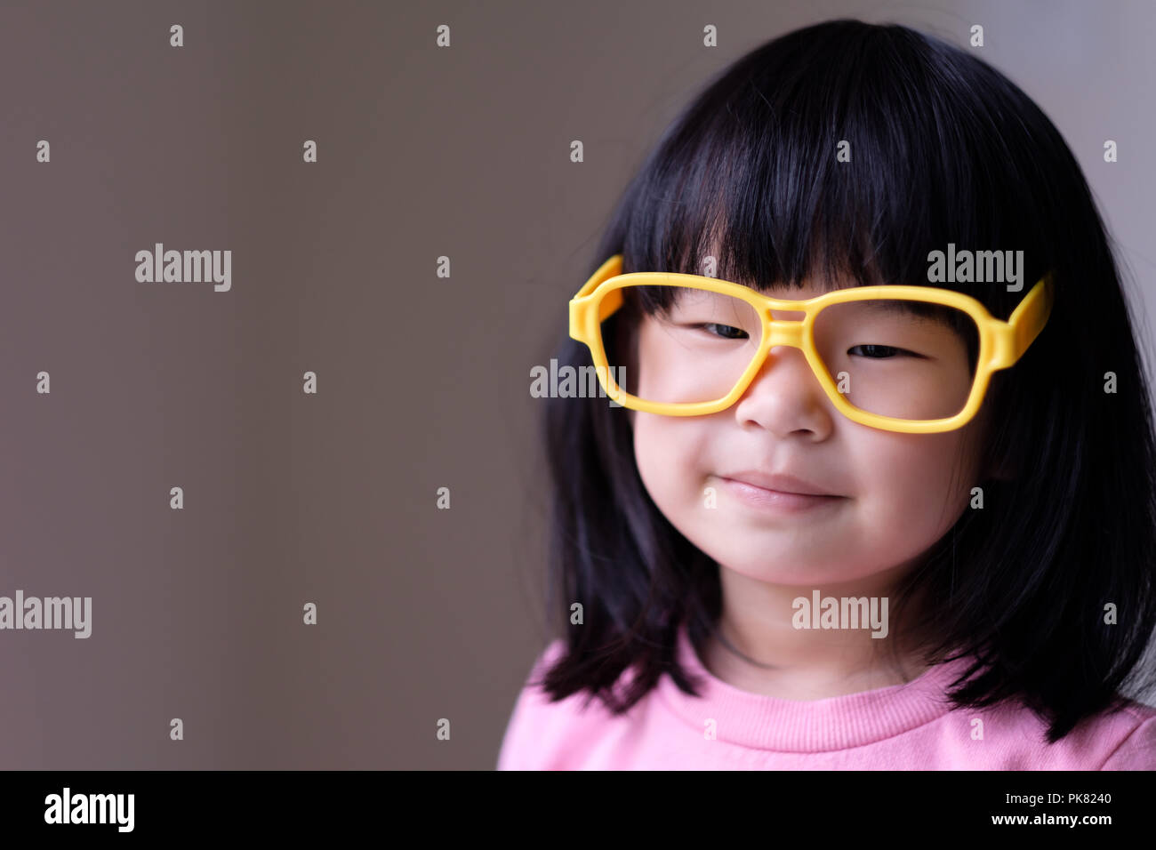 Funny little child with big yellow glasses Stock Photo Alamy