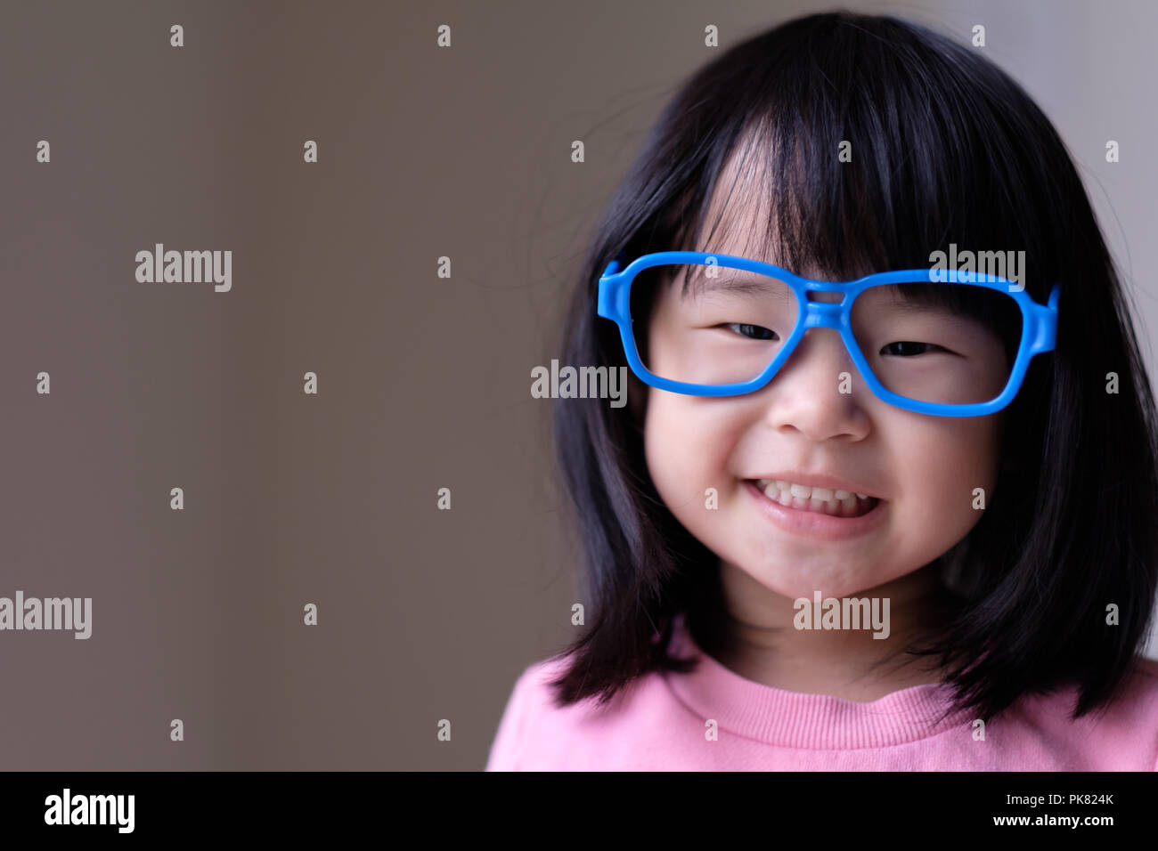 Funny little child with big blue glasses Stock Photo