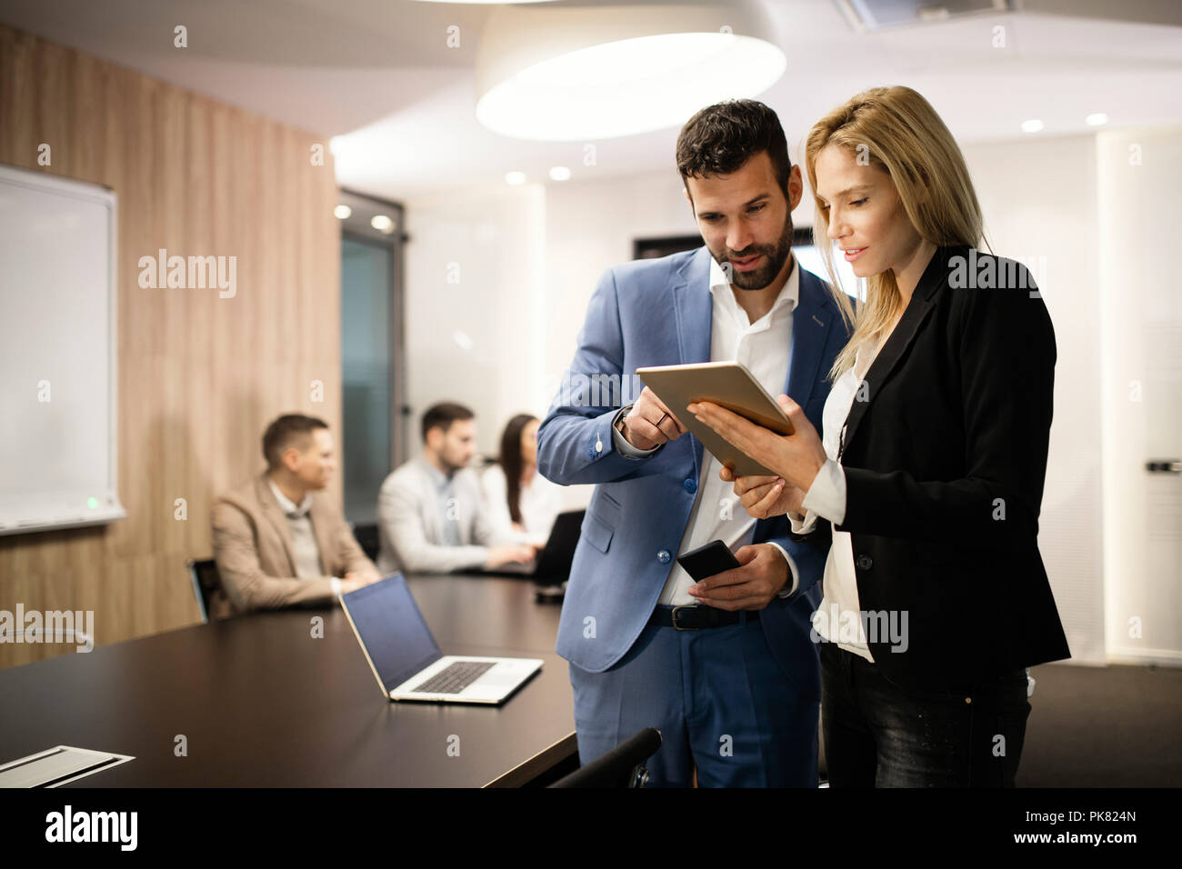 Portrait of attractive business partners using tablet Stock Photo