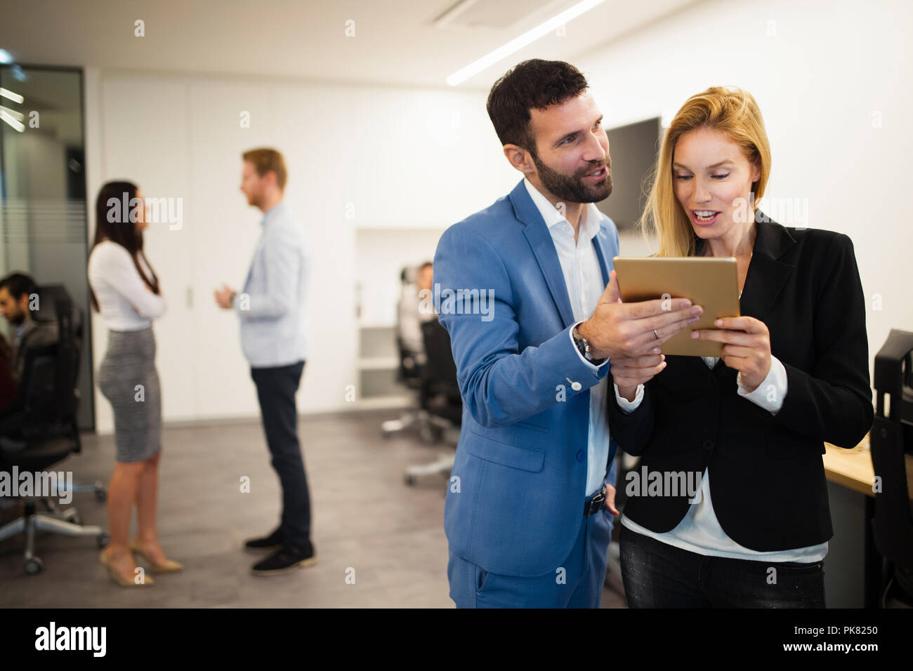 Portrait of attractive business partners using tablet Stock Photo
