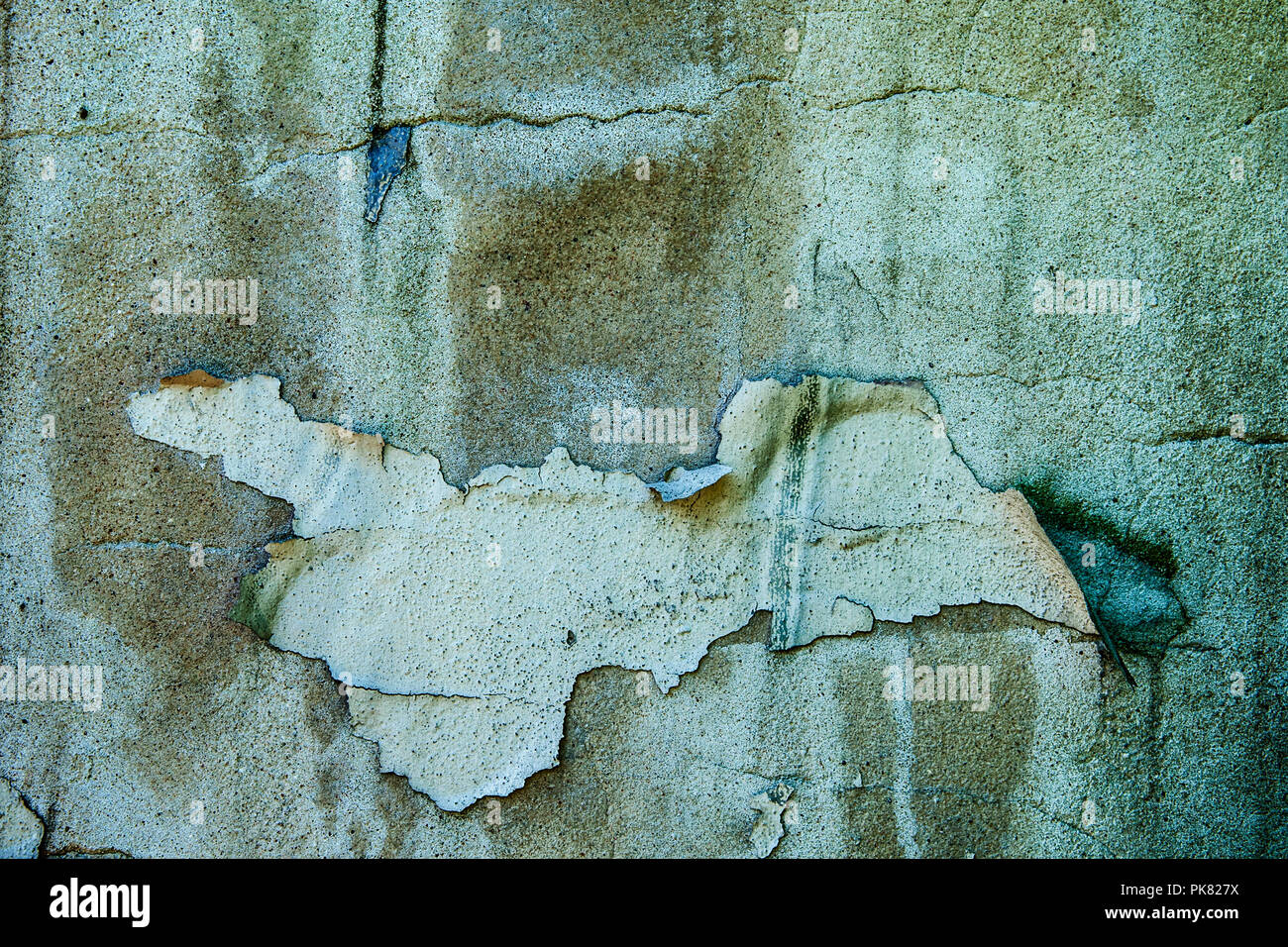 Grunge old concrete wall with peeling paint. Stock Photo