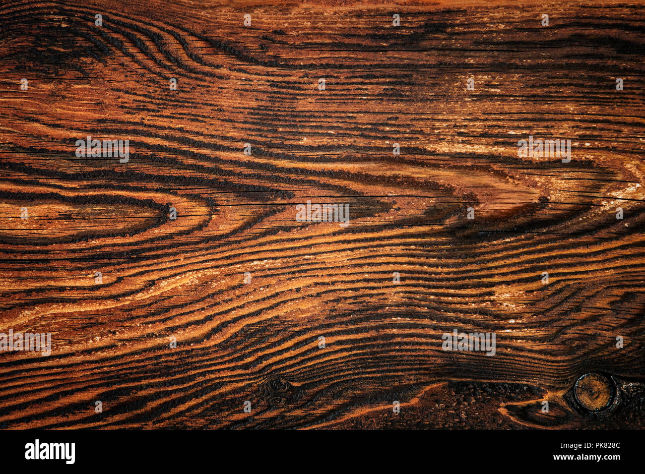 Closeup of an old rich wood grain texture background with knots. Stock Photo