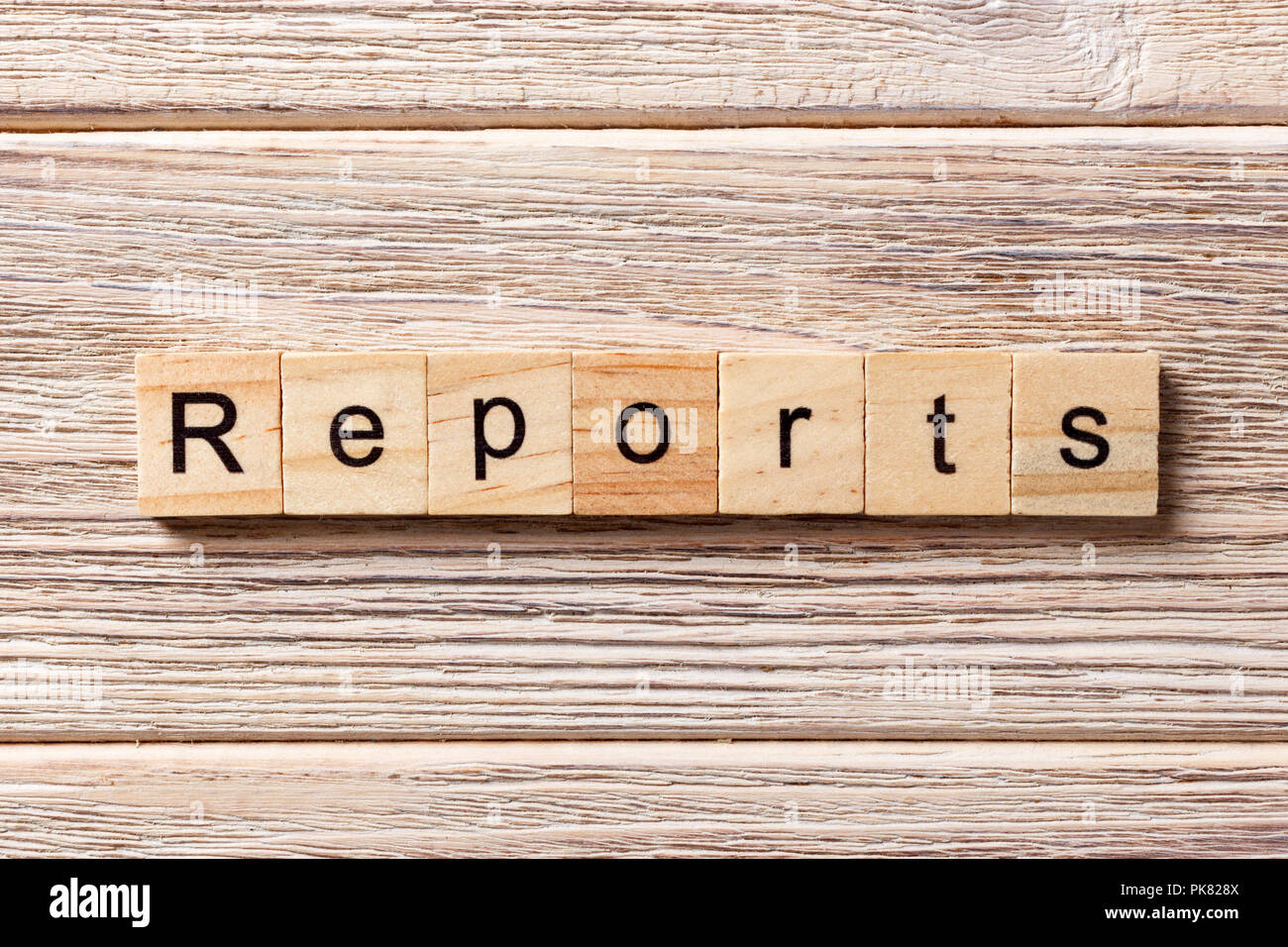 REPORTS word written on wood block. REPORTS text on table, concept. Stock Photo