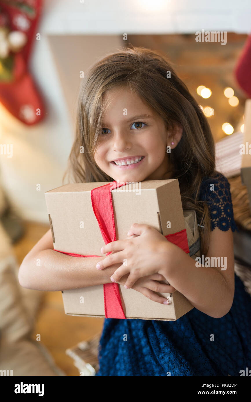 Childhood. Young girl during Christmas eve Stock Photo - Alamy