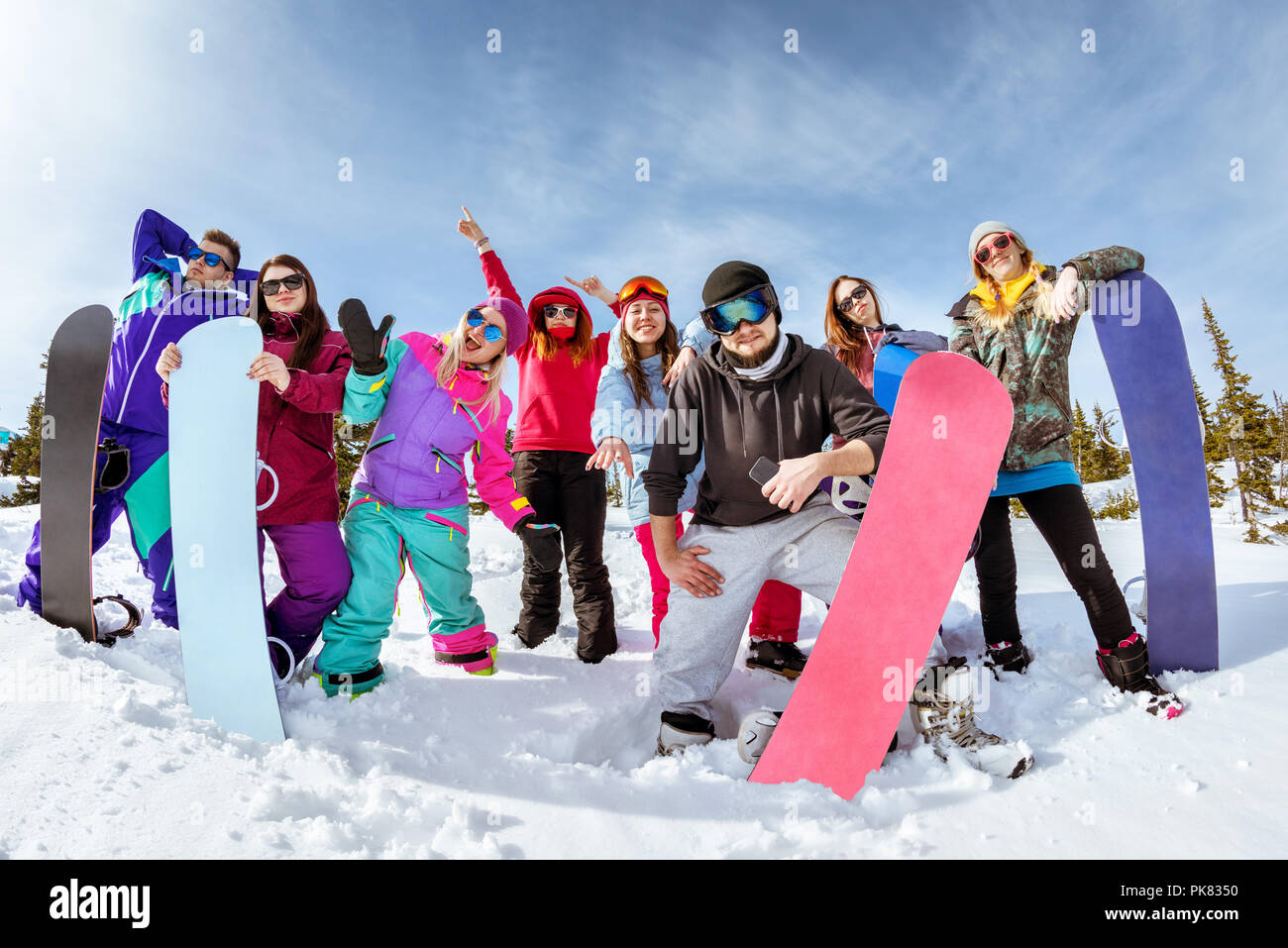 Group of happy friends snowboarders having fun at ski resort. Winter vacations concept Stock Photo