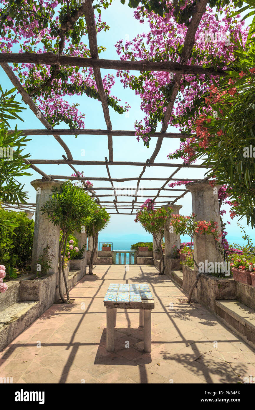 Through the pergola with flowers sun shines. Ravello, scenic view of the Amalfi Coast from Villa Rufolo. Italy. Stock Photo