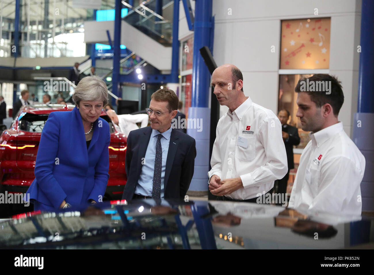 Prime Minister Theresa May and Mayor of the West Midlands' Andy Street, during the Zero Emission Vehicle Summit at the ICC in Birmingham. Stock Photo