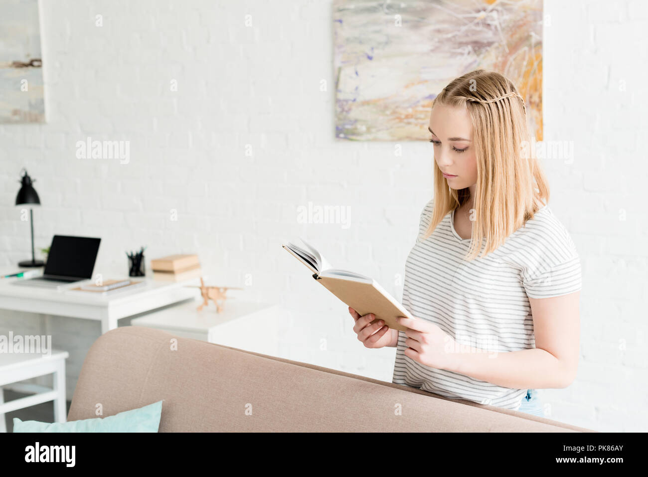 teen student girl reading book at home Stock Photo - Alamy