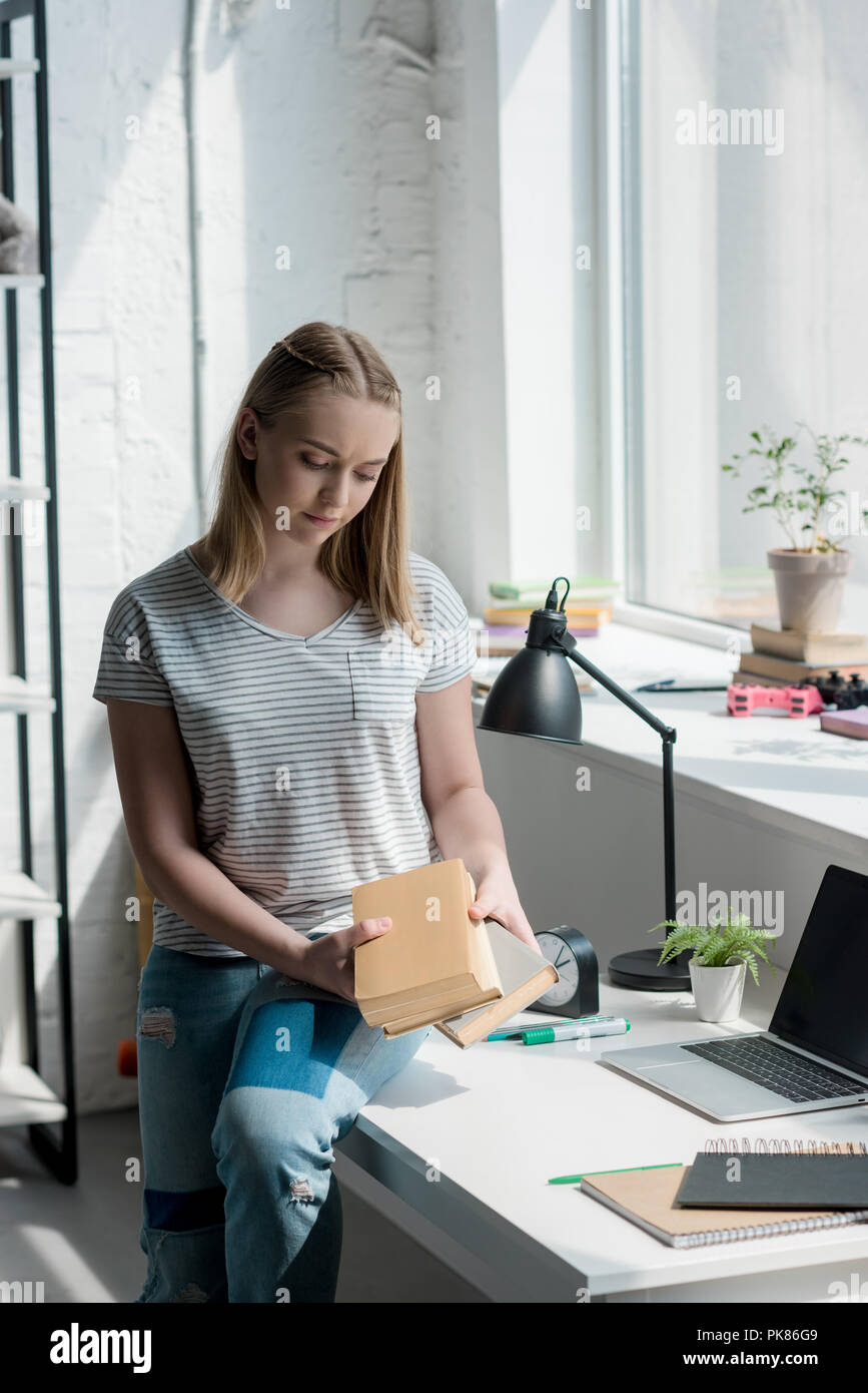 teen student girl with books sitting on work desk at home Stock Photo ...