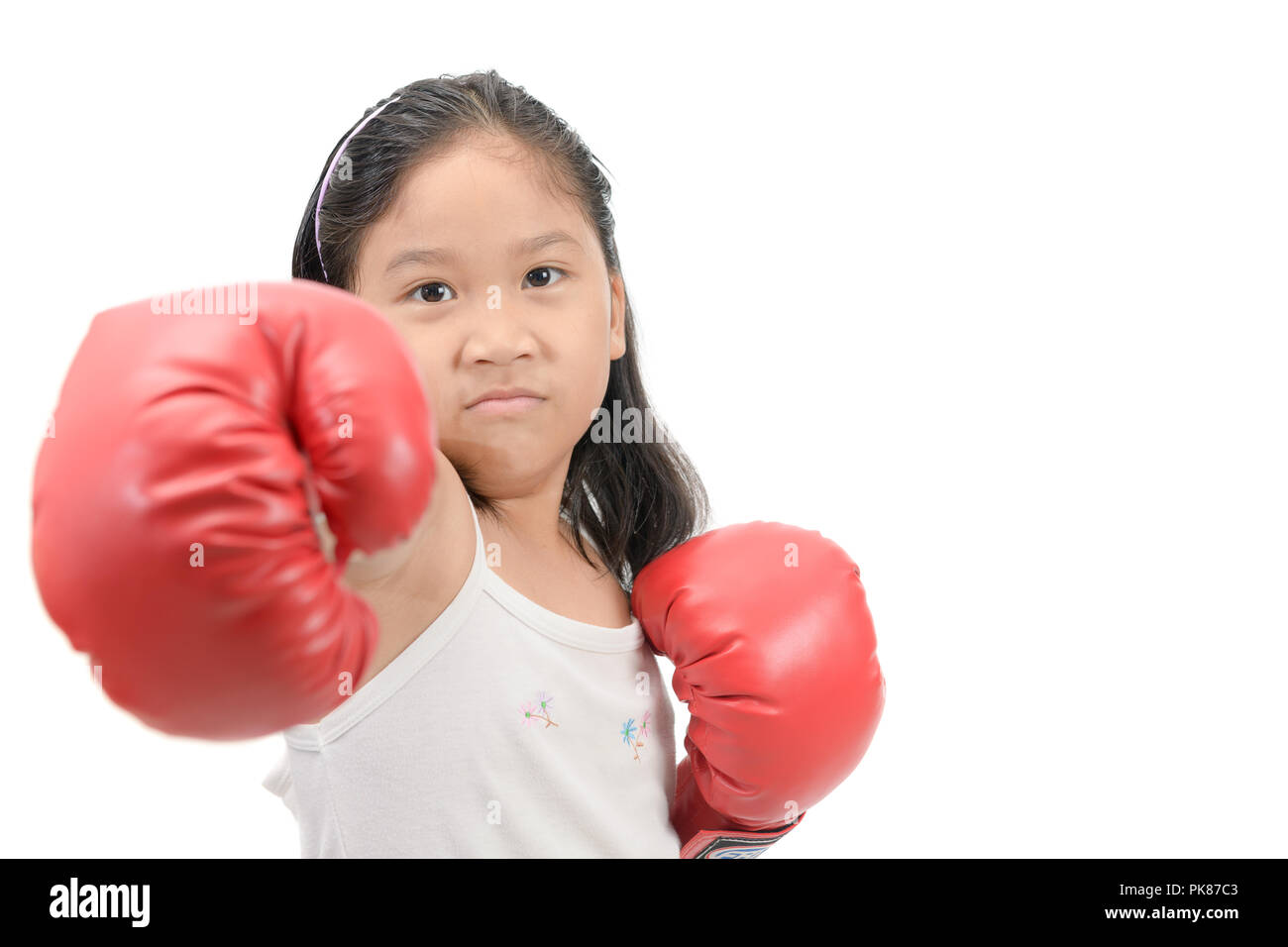 Cute girl fighting with red boxing gloves isolated on white background