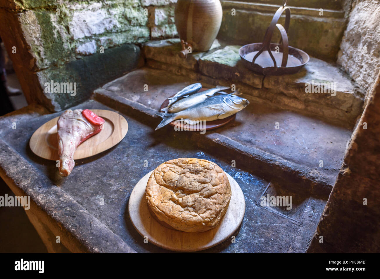 A still life of food eaten in medieval times inside the kitchen stone monastrey. Stock Photo