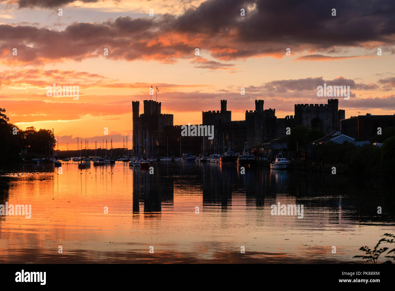 Caernarfon Castle Caernarfon Gwynedd Wales at Sunset Stock Photo