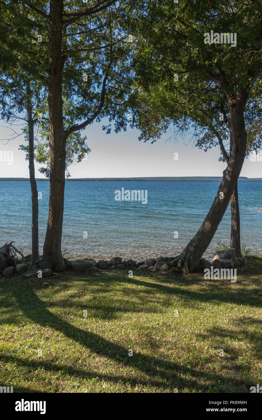 Lake Manitou shoreline landscape with cedar trees and rocks on ...