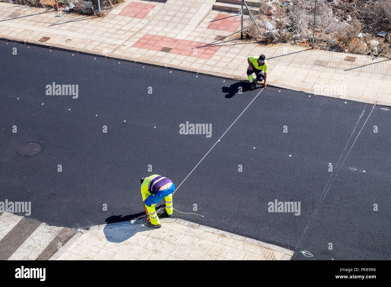 Marking out a newly resurfaced road for painting road markings Stock Photo Alamy