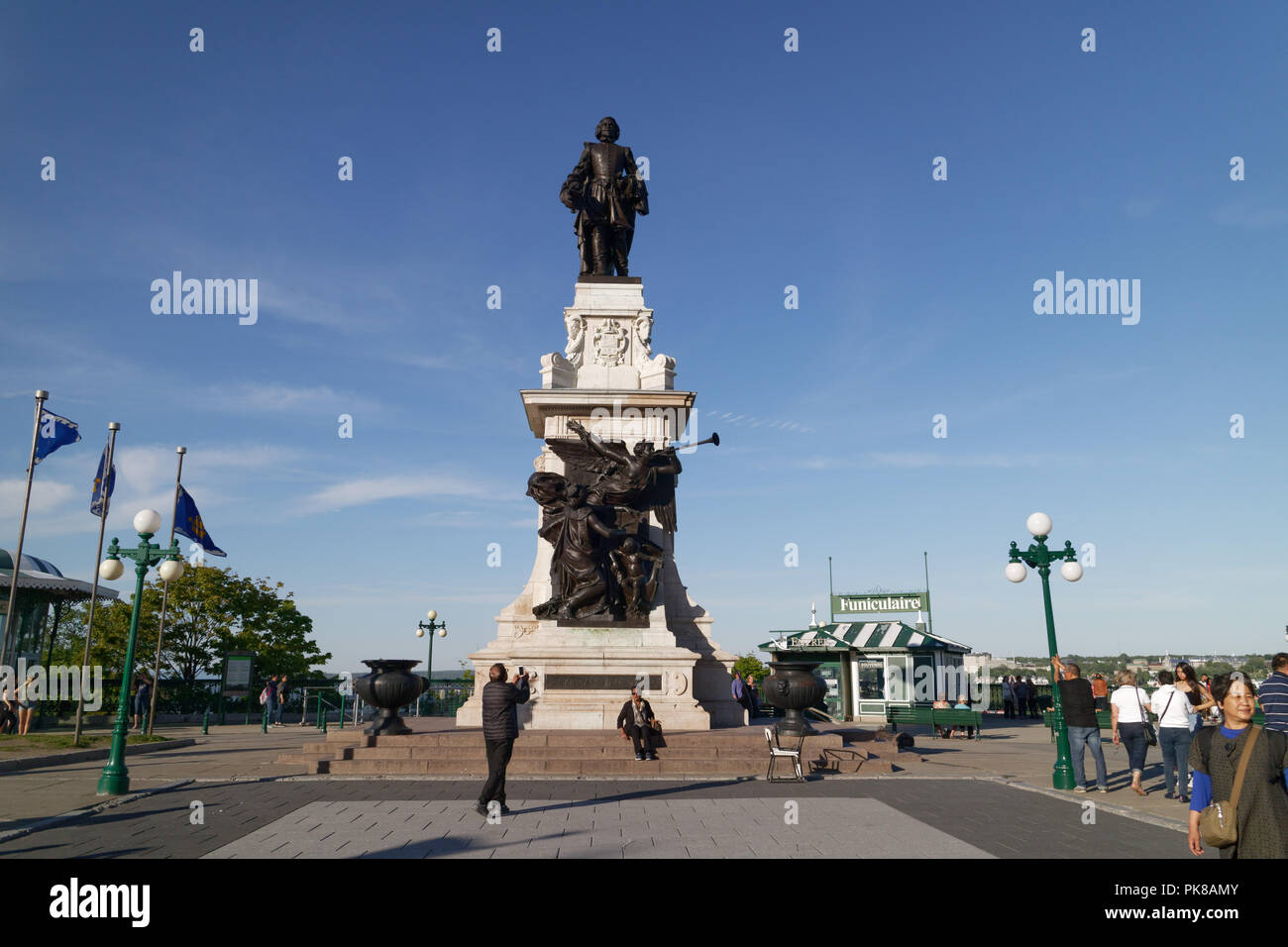 A tourist taking a photo of the statue of Samuel de Champlain on the Terrasse Dufferin, Quebec City, Canada Stock Photo