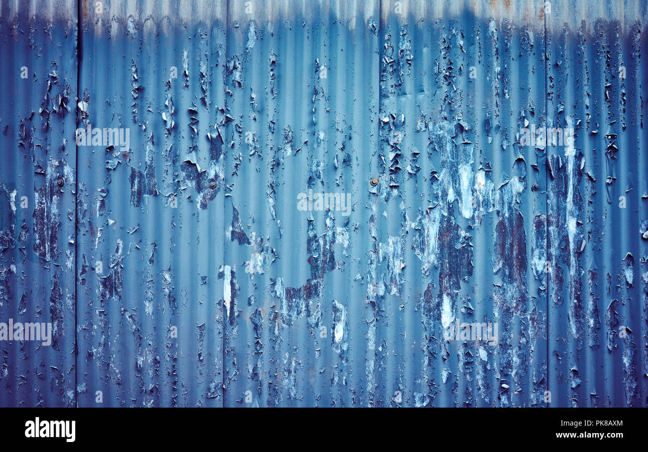 Corrugated metal fence with peeling paint, color toning applied Stock