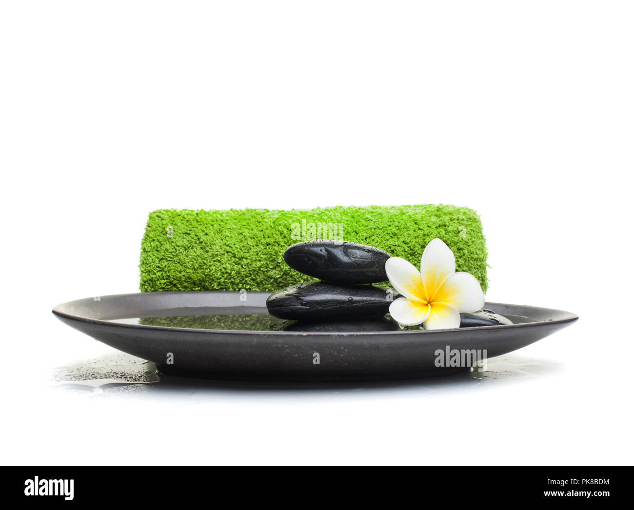 Spa objects and green towel on black plate Stock Photo