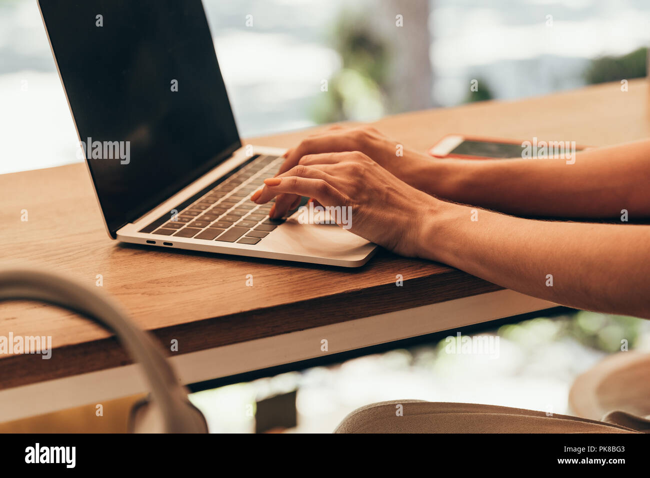 partial view of blogger typing on laptop with blank screen in coffee ...