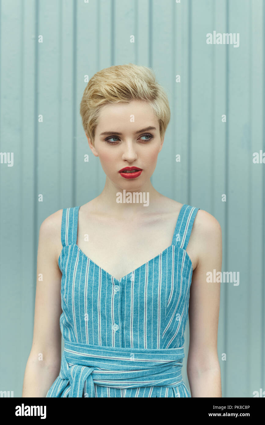 Young Woman With Short Hair Posing In Trendy Blue Dress Stock