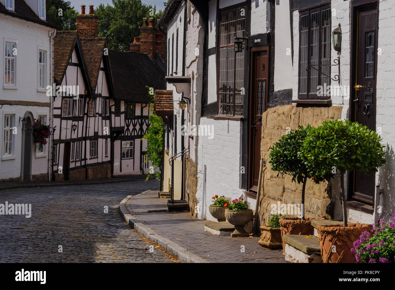Cobbled street with medieval timbered houses in Mill Street Warwick