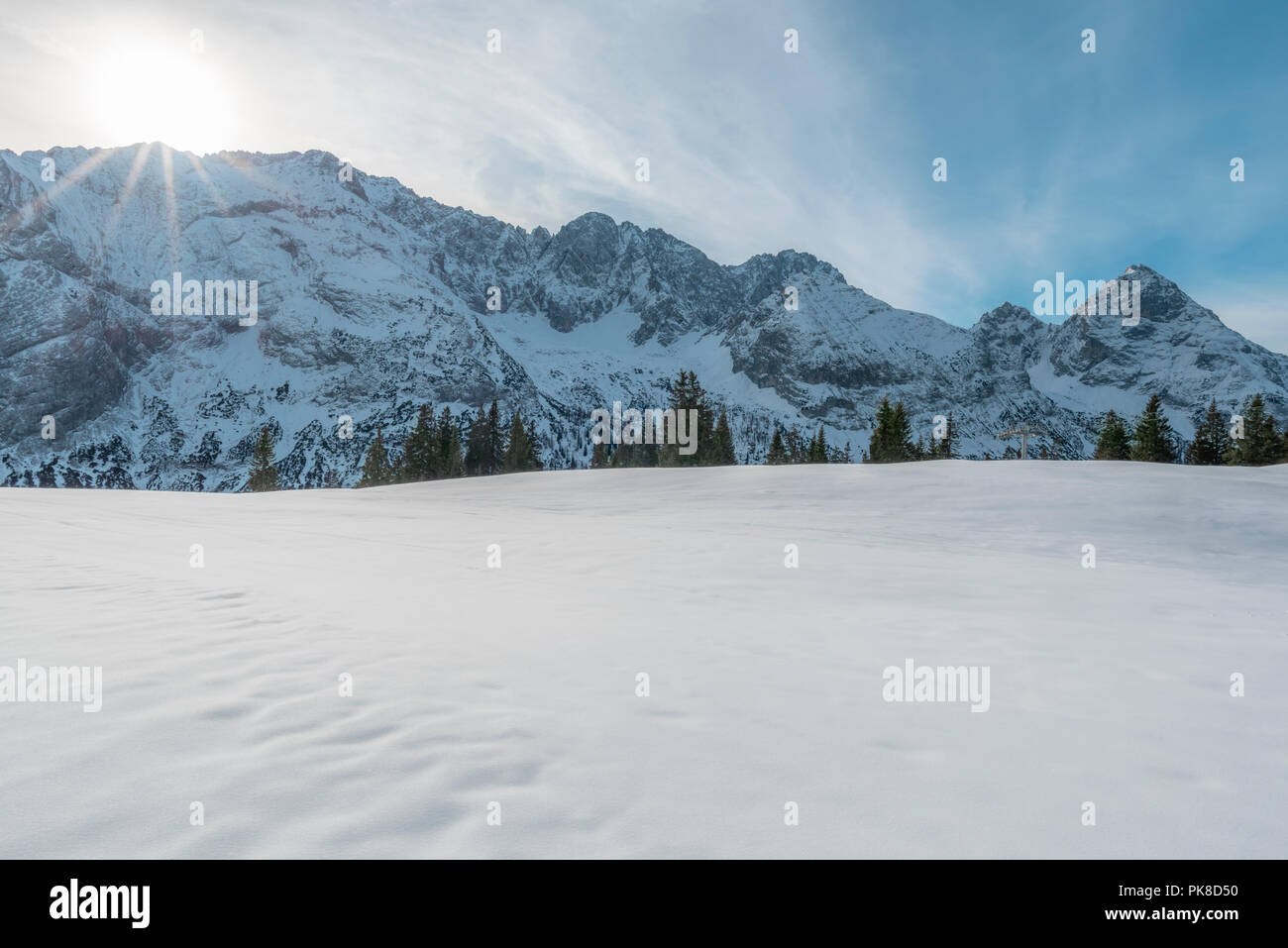 Winter landscape with the Austrian Alps with snow-capped peaks and a snowy valley, on a sunny day in December, in Ehrwald, Austria. Stock Photo