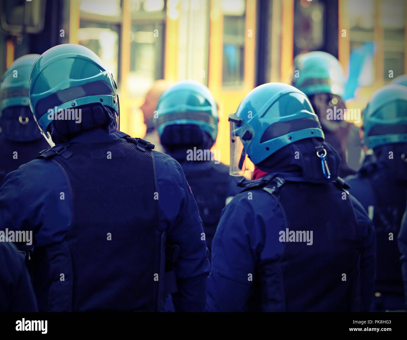 many cops in uniform with helmets with vintage effect during riot in ...