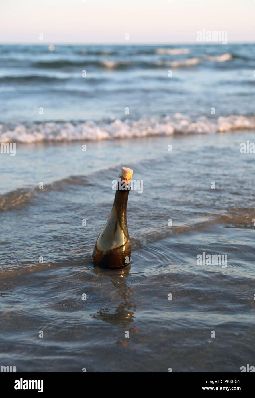 glass bottle with a message inside floats in the sea Stock Photo Alamy