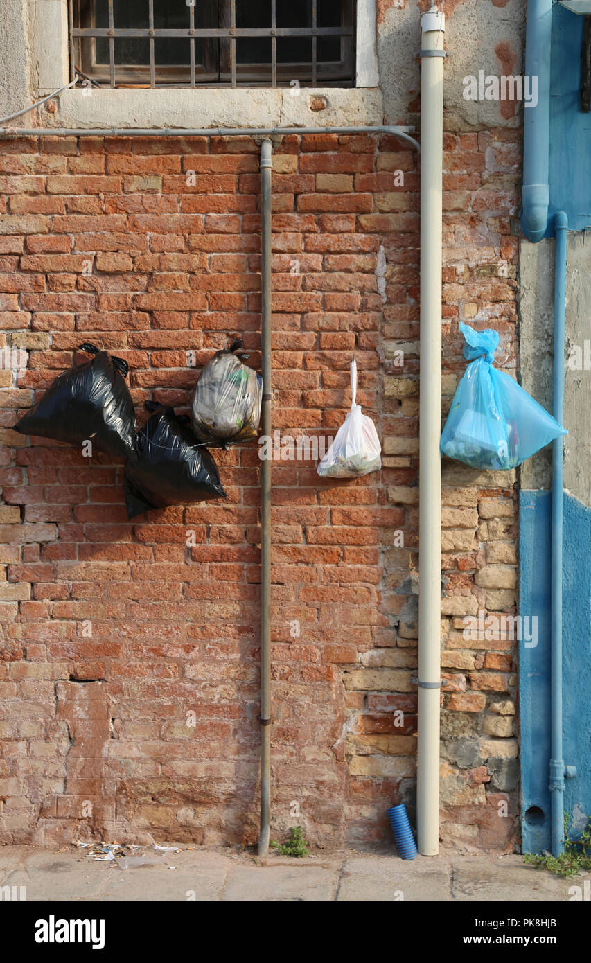 many garbage bags hung on the wall of houses to prevent mice eating