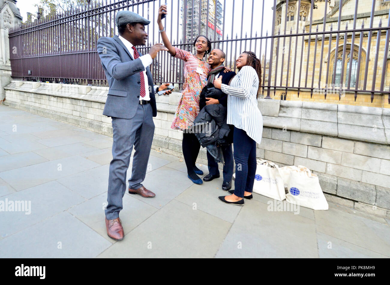 Family posing for a group selfie in front of the Hosues of Parliament, Westminster, London, England, UK. Stock Photo