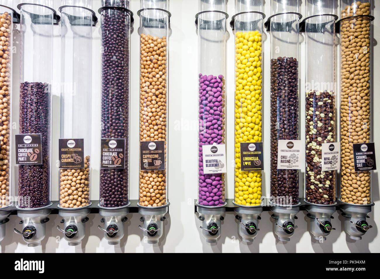 Front view of variety of chocolate candy dispensers in a candy store in Bruges, Belgium Stock Photo