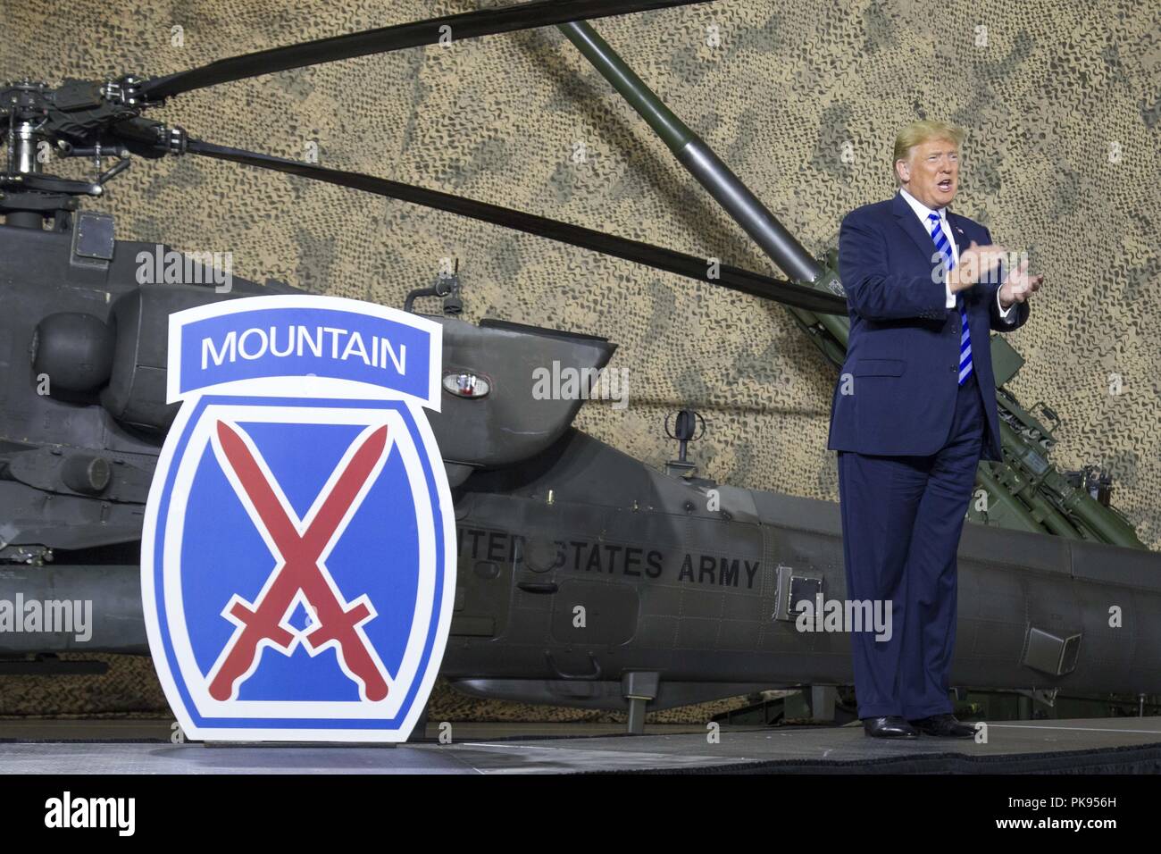 President Donald J. Trump applauds 10th Mountain Division (LI) Soldiers at Fort Drum, New York, on August 13, August 13, 2018. President Trump was visiting the U.S. Army post to sign the National Defense Authorization Act of 2019, which raises Soldier pay by 2.6 percent recognizing the service and sacrifice they make on behalf of our Nation. (U.S. Army photo by Sgt. Thomas Scaggs) 180813-A-TZ475-851. () Stock Photo