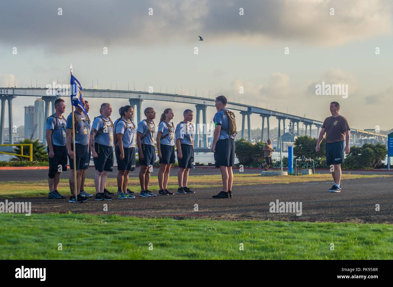 180813-N-NT795-840 CORONADO, Calif. (August 13, 2018) Chief Master-at-Arms Douglas Dawson assigned to Coastal Riverine Group (CRG) 1, leads the basic formation drill to chief petty officer (CPO) selectees during CPO initiation onboard Naval Amphibious Base Coronado, August 13, 2018. CPO initiation is a professional education and training environment that starts when the announcement message is released, and time-honored tradition focused on the team/individuals as leaders of integrity, accountability, initiative and toughness. (U.S. Navy photo by Chief Boatswain's Mate Nelson Doromal Jr/Releas Stock Photo