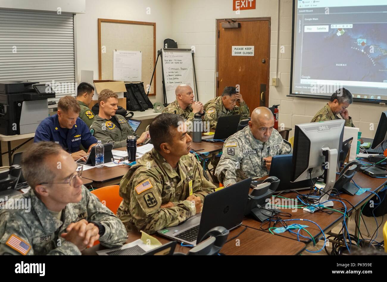 Service members with Joint Task Force 5-0 receive a daily commander's update brief, August 25, 2018 at the Hawaii Army National Guard Center at Diamond Head, Honolulu Hawaii, August 24, 2018. JTF 5-0 is a joint task force led by a dual status commander that is established to respond to the effects of Hurricane Lane on the state of Hawaii. The members of the task force remain committed to monitoring the effects and incidents across the state of Hawaii to respond to any requests made by Local and state authorities through FEMA. () Stock Photo