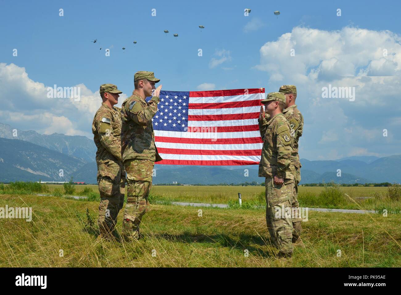During a airborne operation, Staff Sgt. Daniel Clark (right) assigned to the 2nd Battalion, 503rd Infantry Regiment, 173rd Airborne Brigade, swears the oath of re-enlistment to 2nd Lt. Jack Barnett (left) at Juliet Drop Zone, Pordenone, Italy, August 22, 2018, August 22, 2018. The 173rd Airborne Brigade is the U.S. Army Contingency Response Force in Europe, capable of projecting ready forces anywhere in the U.S. European, Africa or Central Commands' areas of responsibility. (U.S. Army photo by Paolo Bovo). () Stock Photo