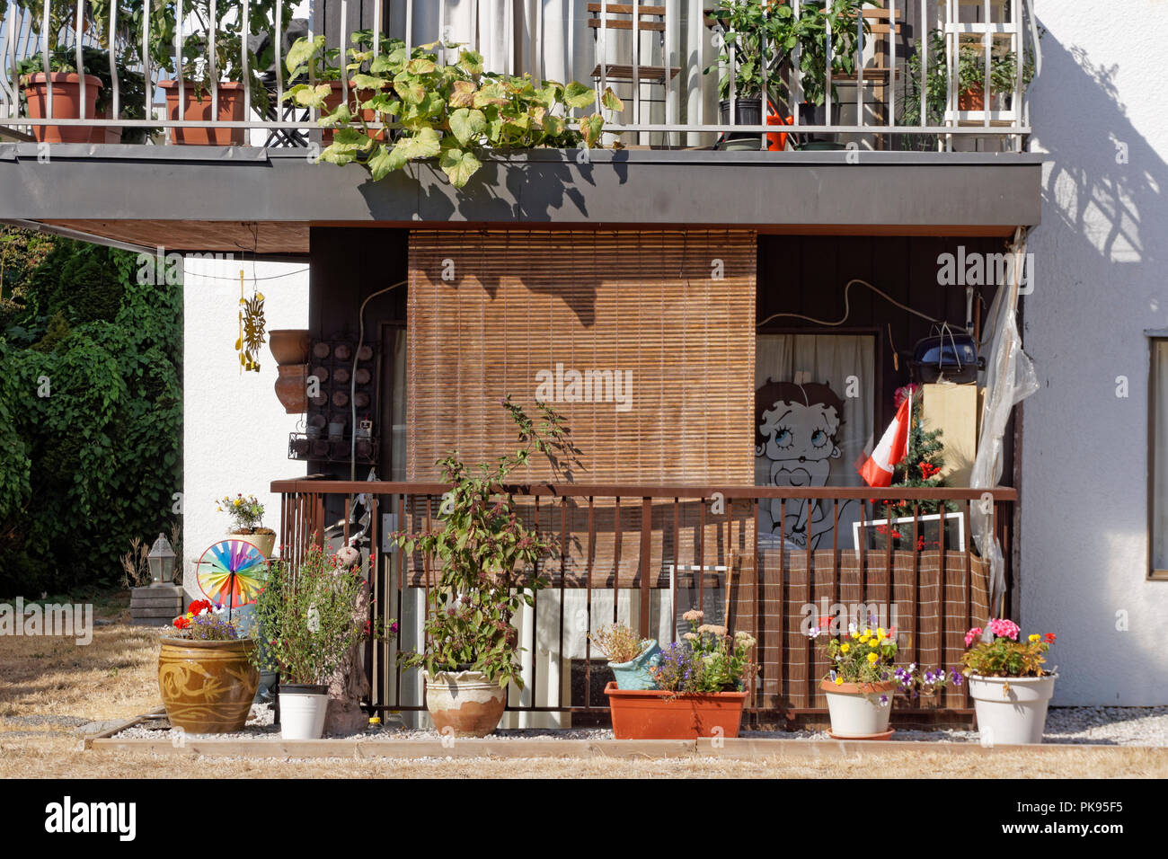 Cluttered ground floor balcony of an apartment in Kitsilano, Vancouver, BC, Canada Stock Photo