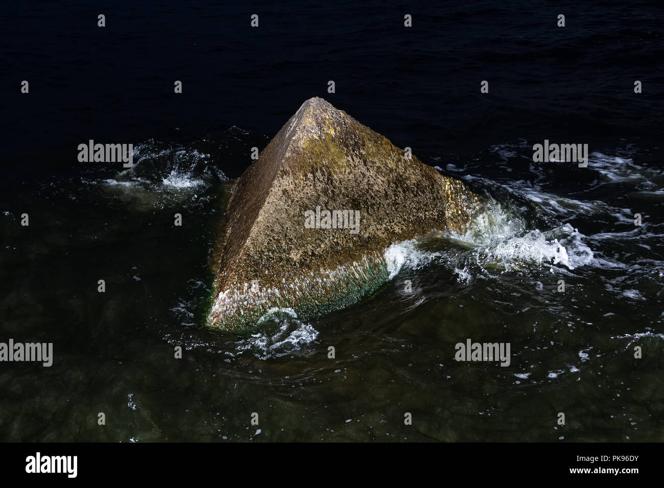 Granite wavebrakers in a Gulf of Riga, Latvia after sunset in August Stock Photo