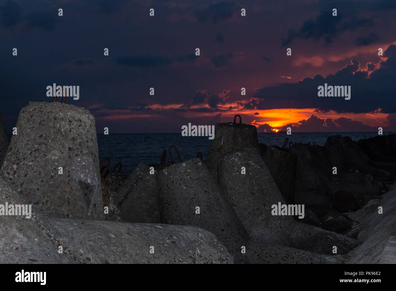 Granite wavebrakers in a Gulf of Riga, Latvia after sunset in August Stock Photo