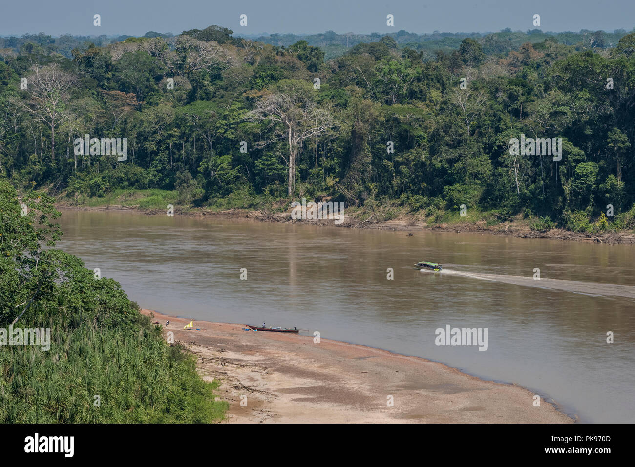 A view of the Amazon jungle near the Madre de Dios river, several boats are visible as that is the preferred mode of transportation with no roads. Stock Photo