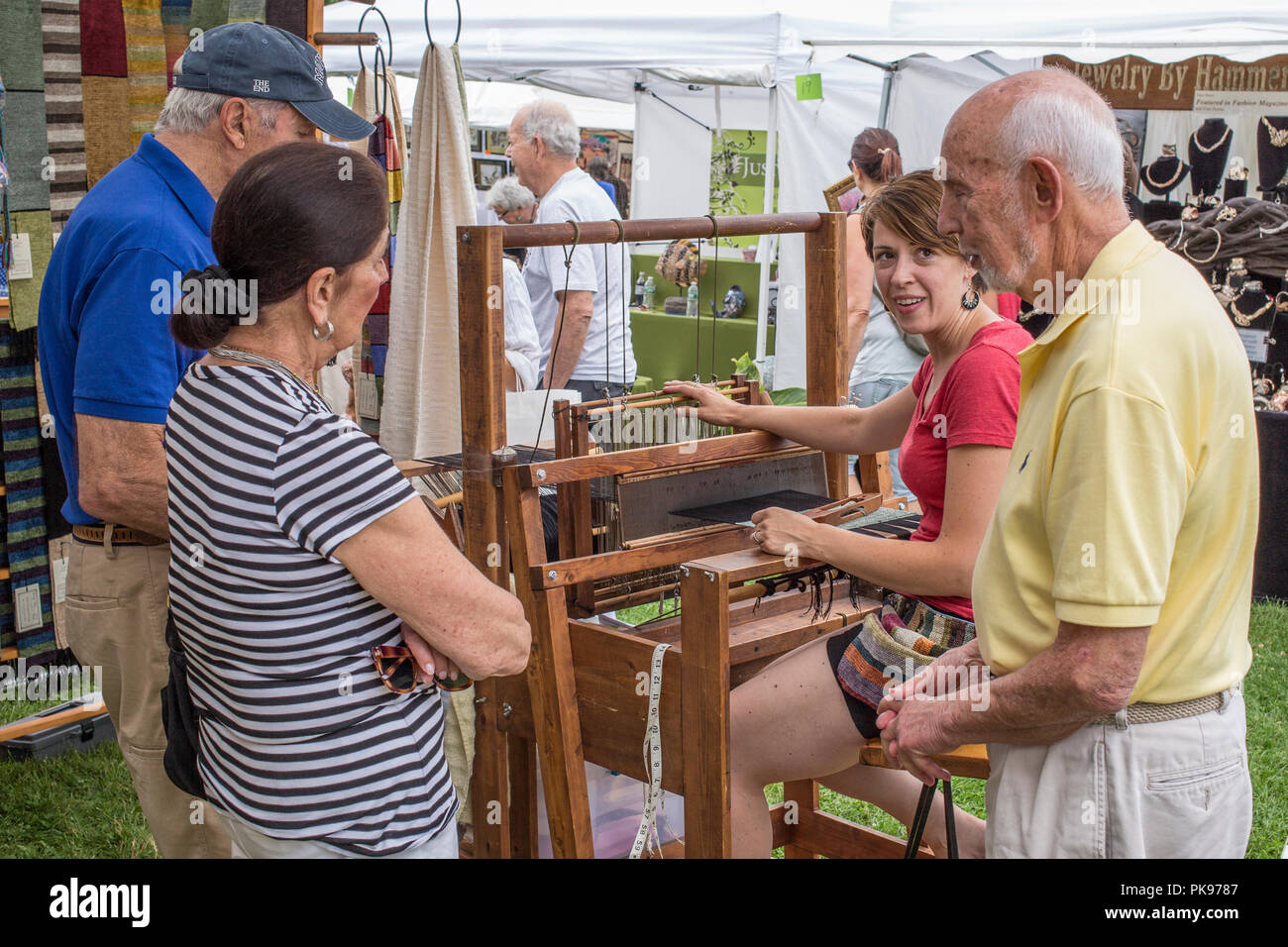 A woman weaving at an arts and craft fair in Lenox, MA Stock Photo