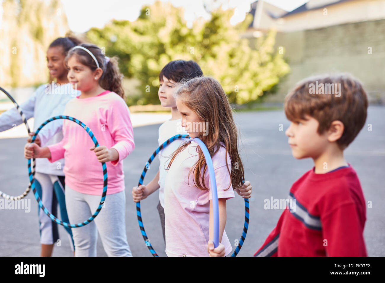 Group of kids is playing with tires in summer camp or kids leisure Stock Photo