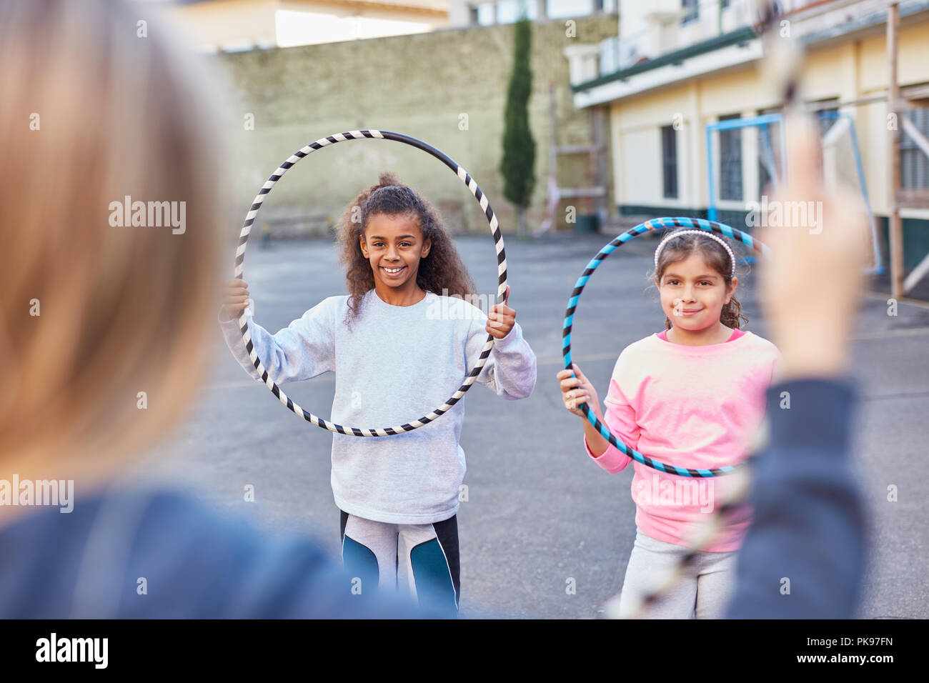 Girls do gymnastics with hoops at school sports or summer camp Stock Photo