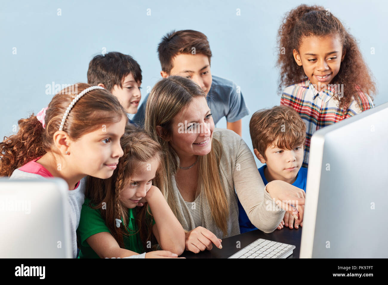 Pupils group learns together on the computer in the internet class Stock Photo