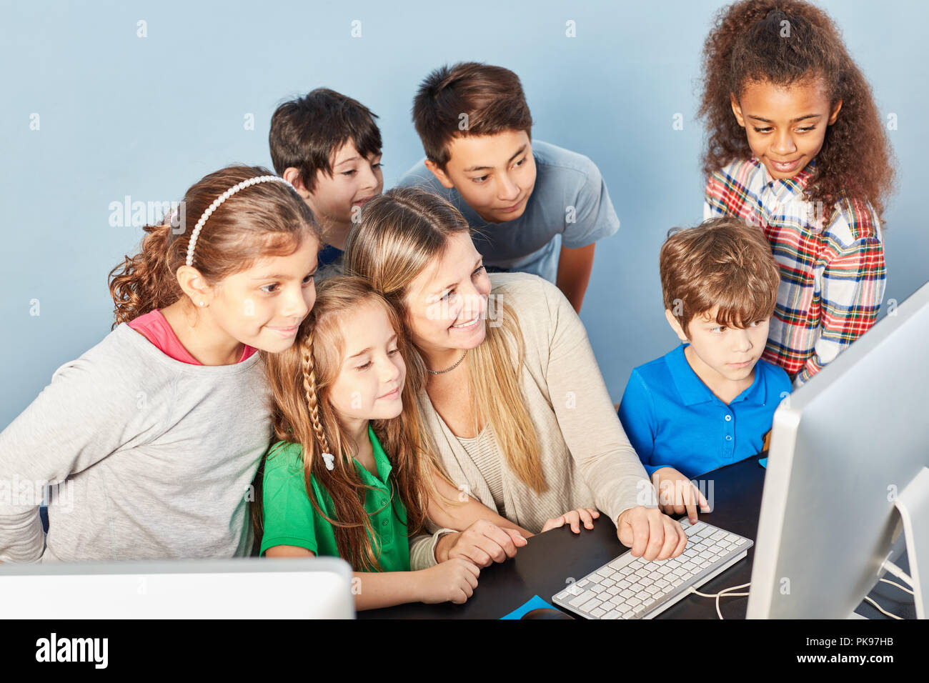 Group of pupils in e-learning in the computer science course of elementary school Stock Photo