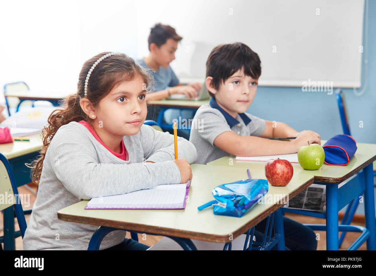 Pupils in elementary school writing a dictation and watching Stock ...