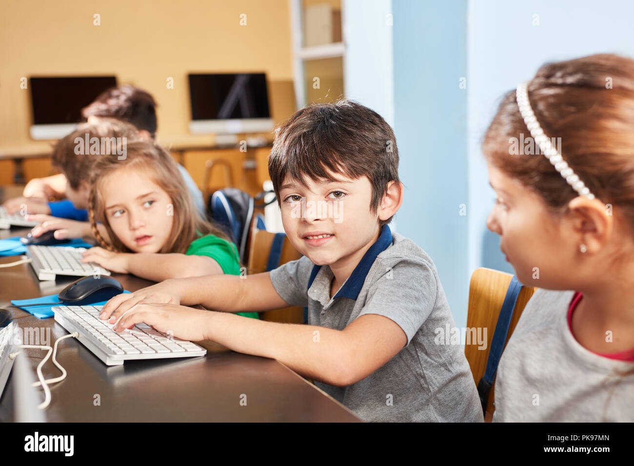 Boy as a student at the computer in computer science teaching elementary school Stock Photo