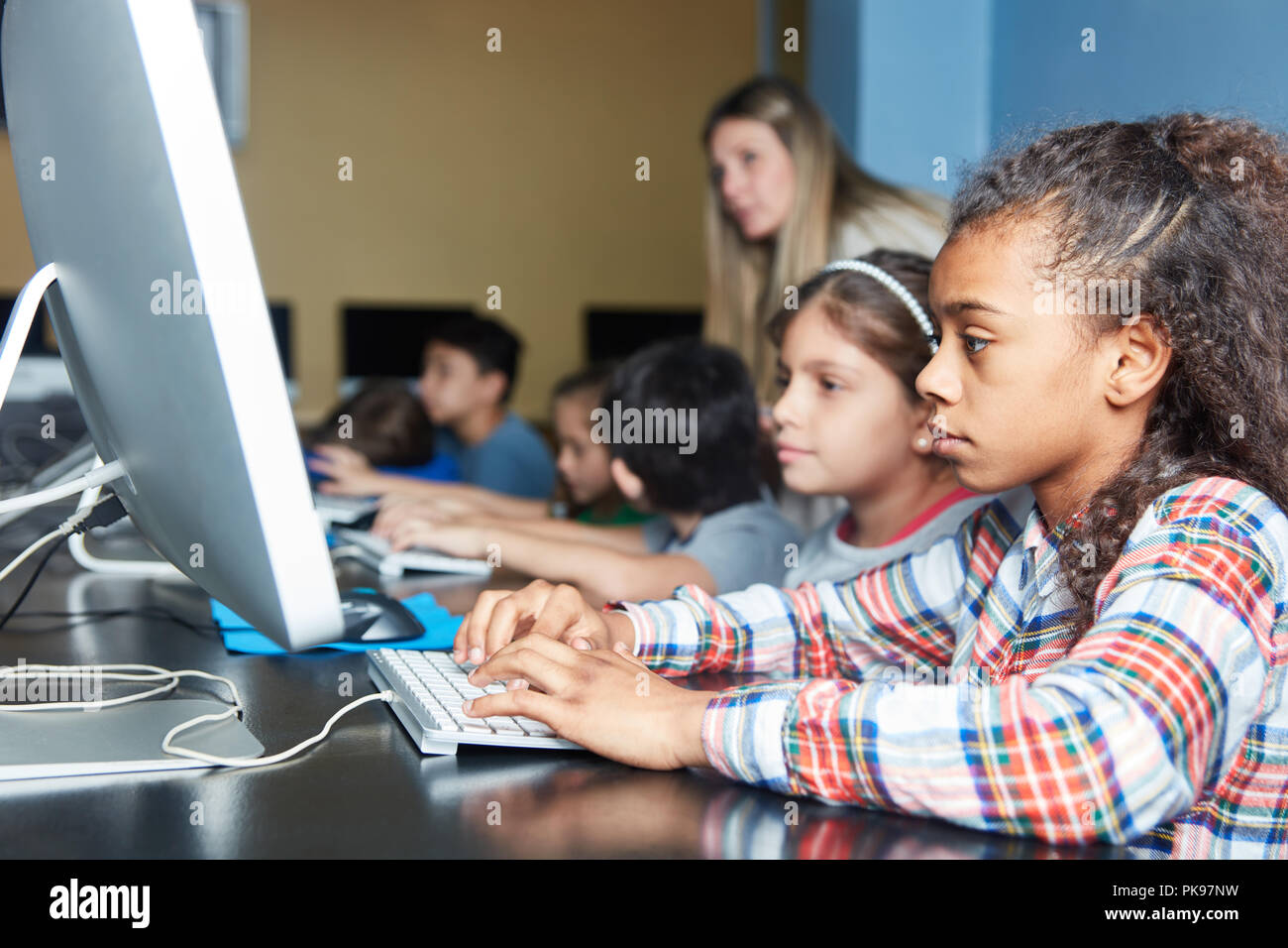 Children learn at the computer in computer science lessons of elementary school Stock Photo